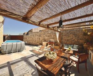 a patio with a wooden table and a wooden pergola at Dimora del Monte "I Limoni ","L Ulivo " in Ragusa