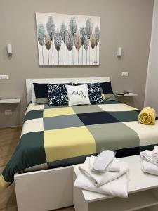 a bedroom with a bed with a checkerboard patterned comforter at Midnight Sun in Vietri sul Mare