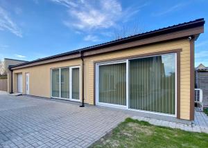 a house with large sliding doors on it at Hoovimaja in Pärnu