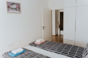 two beds with towels on them in a room at Stan Brana in Ruma