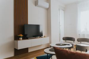 a living room with a television and two chairs at Stan Brana in Ruma