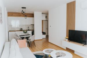 a living room with a white couch and a table at Stan Brana in Ruma