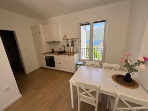 a kitchen and dining room with a table and chairs at Apartments Laura in Korčula
