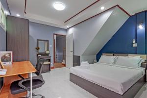 a bedroom with a large bed and a desk and a desk at Large Spacious 3BR House at BTS ON NUT in Phra Khanong