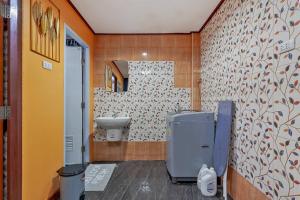 a bathroom with a toilet and a sink and a mirror at Large Spacious 3BR House at BTS ON NUT in Phra Khanong +52 photos