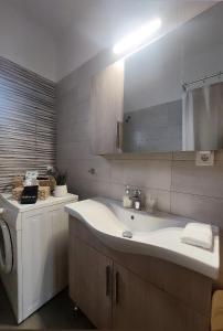 a bathroom with a sink and a mirror at Mentis Home in Artemida +23 photos