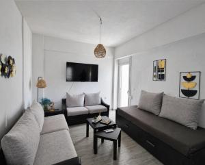a living room with a couch and a table at Mentis Home in Artemida