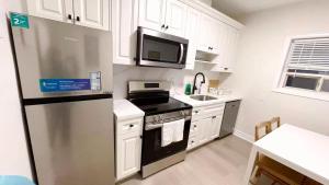 a kitchen with a stainless steel refrigerator and a microwave at Queen Boutique Rooms in Toronto +33 photos