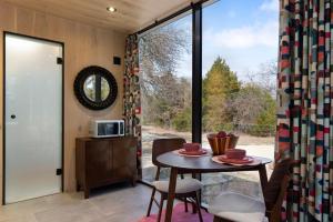 a room with a table and a large window at Mod Squad in Saint Jo