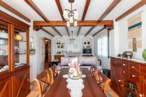 a kitchen and dining room with a table and chairs at Casa Xardín in O Pedrouzo +32 photos