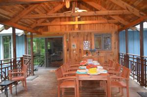 a wooden dining room with a table and chairs at Shimmering Cove Retreat in Naples