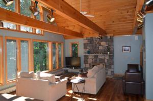 a living room with two couches and a tv at Shimmering Cove Retreat in Naples