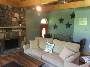 a living room with a couch and stars on the wall at Shimmering Cove Retreat in Naples +33 photos