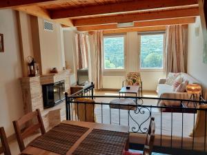 a living room with a couch and a fireplace at Rastoni Apartments in Andros