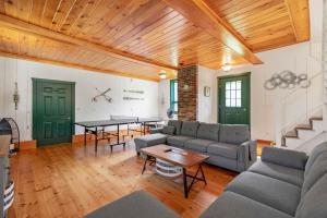 a living room with a couch and a table at Shimmering River Retreat in Edgecomb
