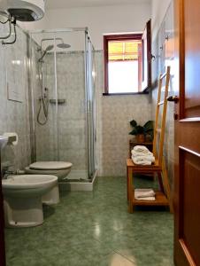 a bathroom with a shower and a toilet and a sink at Casa Rina in Piano Conte +26 photos
