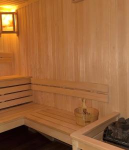 a wooden sauna with a bucket in it at Hotel Elion in Yerevan