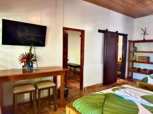 a bedroom with a bed and a desk and a table at Azure Del Mar in Maya Beach