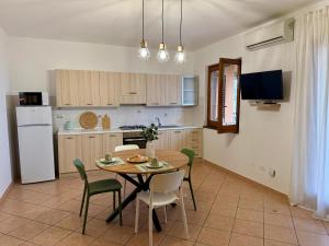 a kitchen with a table and chairs in a kitchen at Casa Rina in Piano Conte