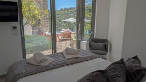 a bedroom with a bed and a large window at Villa Levanda in Kiveri +17 photos
