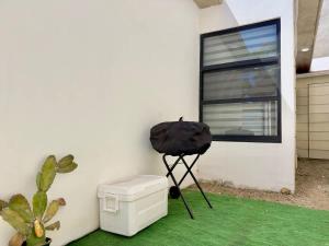 a camera on a tripod next to a white wall at House Ayala 2BR 2Bd in Rosarito
