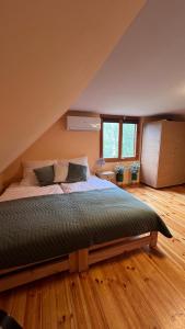 a bedroom with a large bed in an attic at Leonówka in Nowogród