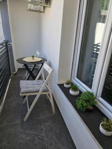 a small table and a chair on a balcony at Private bedroom with bathroom in Baška Voda +12 photos