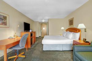 a hotel room with a bed and a desk and a computer at Prairie Crest Red Deer by IHG in Red Deer +23 photos