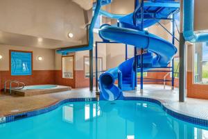 a water slide in a pool at a hotel at Prairie Crest Red Deer by IHG in Red Deer