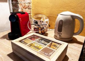 a table with a tray of food and a tea kettle at Dimora del Campanile in Torrita di Siena