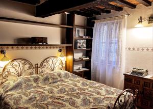 a bedroom with a bed and a window at Dimora del Campanile in Torrita di Siena