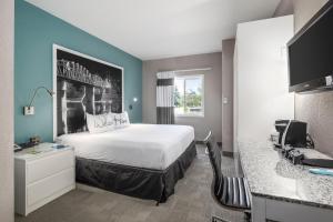 a hotel room with a bed and a desk at Prairie Crest Medicine Hat by IHG in Medicine Hat