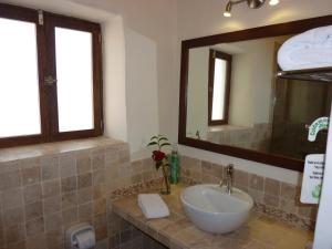 a bathroom with a sink and a mirror at Kutty Wasi in Cusco