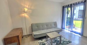 a living room with a couch and a table at Appartamento CHAN in Cama
