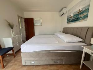 a bedroom with a large bed in a room at Roso Seafront House in Selca kod Bogomolja +12 photos