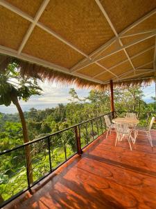 a balcony of a house with a table and chairs at Oceanview Cottage Cempaga - entire 2 BR Bungalow 135 sqm in Temukus +7 photos