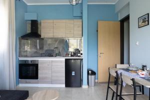 a kitchen with a black refrigerator and a table at Lanari Valley House 2 in Thermi