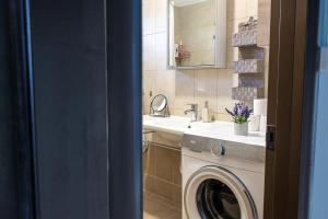 a bathroom with a washing machine and a sink at Lanari Valley House 2 in Thermi +28 photos