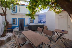 a patio with tables and chairs and a bath tub at Refúgio Alentejano in Alandroal +41 photos