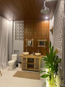 a bathroom with a sink and a toilet at Oceanview Cottage Cempaga - entire 2 BR Bungalow 135 sqm in Temukus