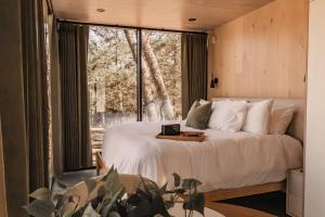 a bedroom with a bed and a large window at Mod Squad in Saint Jo +289 photos