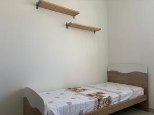 a bed in a room with shelves on the wall at Casa sole cuore amore in Torre del Lago Puccini