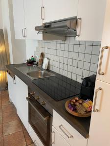 a kitchen with a sink and a plate of food on the counter at Innside - Terrace and Mountain Views in Innsbruck