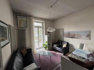 a living room with a couch and a chair at Apartment in Historic Villa in Faido