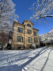 an old house with snow on the ground at Apartment in Historic Villa in Faido