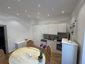 a kitchen with a table and some chairs and a counter at Apartment in Historic Villa in Faido