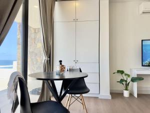 a dining room with a table and two chairs at Little Pearl Sea View Studio in San Antonio del Mar
