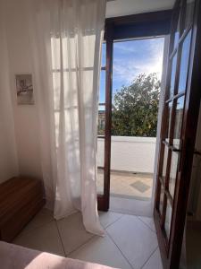 an open door with a view of a balcony at Casa sole cuore amore in Torre del Lago Puccini