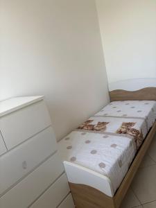 a small bedroom with a bed and a dresser at Casa sole cuore amore in Torre del Lago Puccini