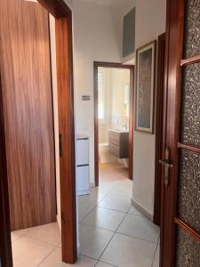 a hallway with a door leading to a bathroom at Casa sole cuore amore in Torre del Lago Puccini